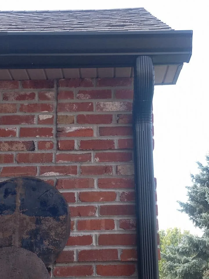 Brick home with a two-car garage and new gutters