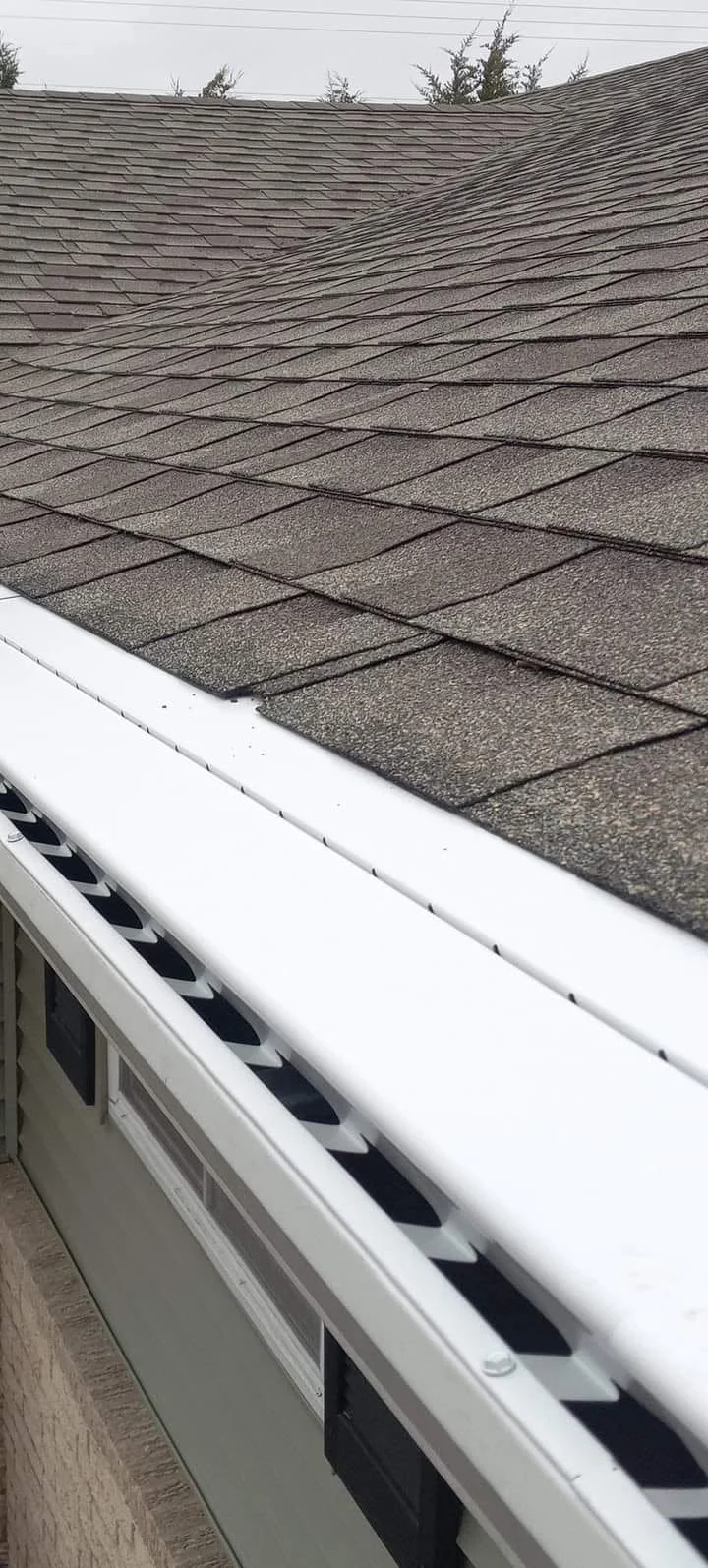 Completed gutter installation along a residential roofline