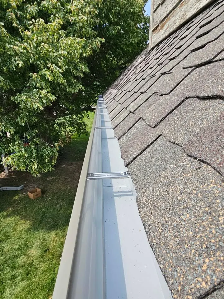 A long unbroken run of newly installed seamless gutter along a residential roofline